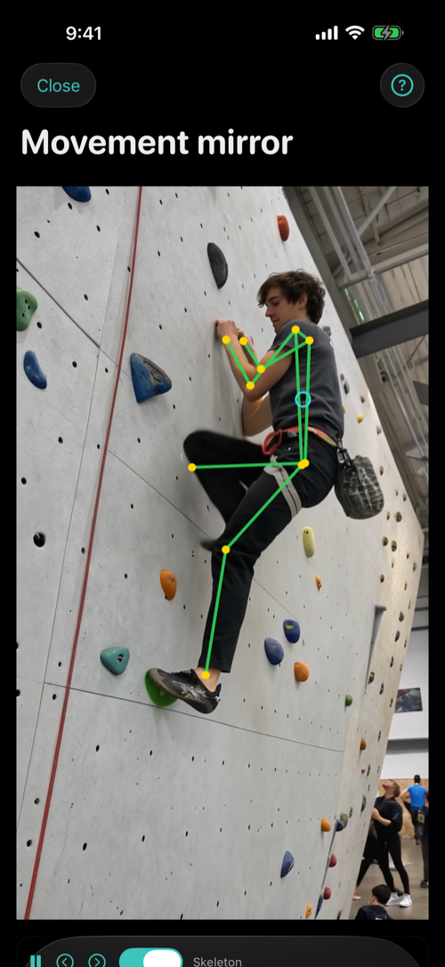 Veraclimb's movement mirror: a green body-pose skeleton overlaid on a climber mid-move on a bouldering wall
